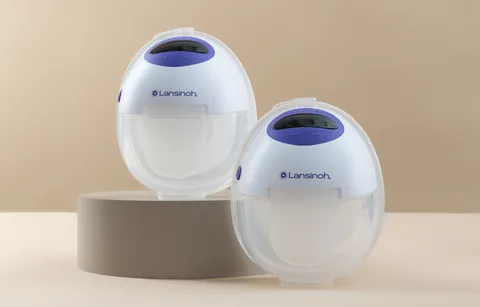 Two Lansinoh DiscreetDuo Flow pumps standing on a beige display