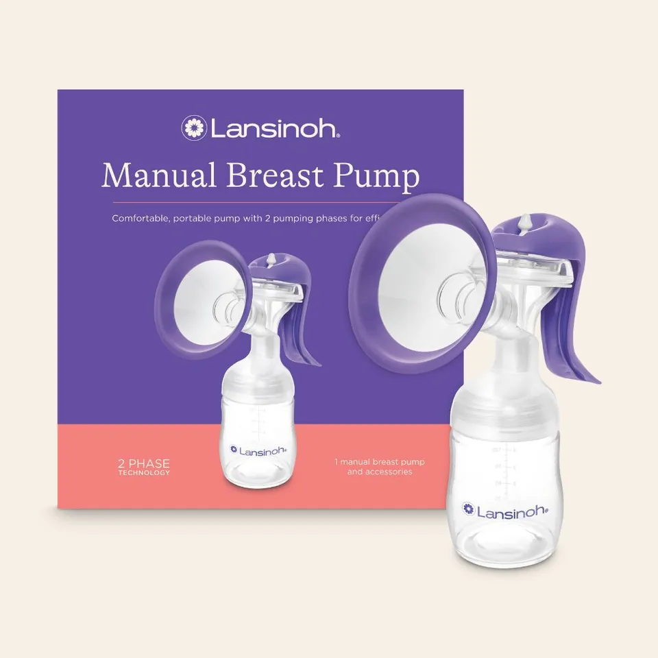 Lansinoh manual pump standing beside its purple-and-pink product box.