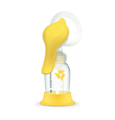Medela Harmony manual pump with yellow handle, breast shield, bottle and stand.