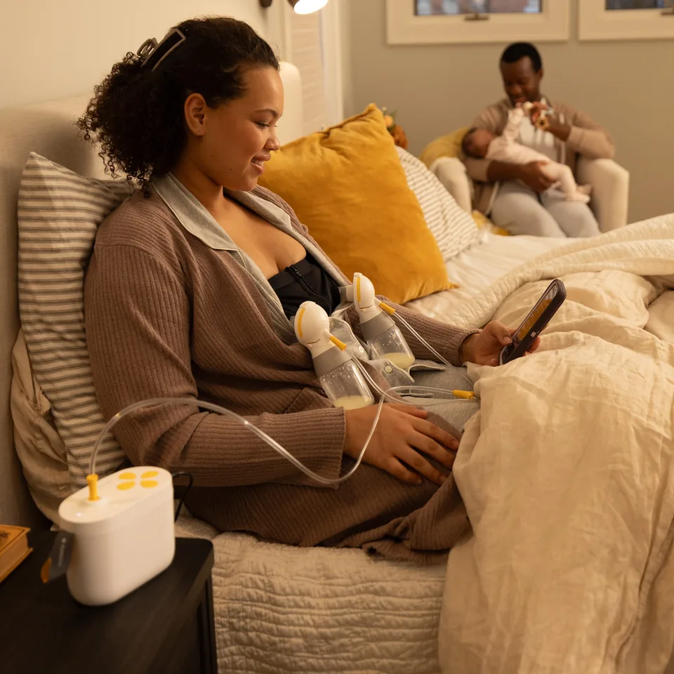 Person using Medela Pump In Style Pro with bottles held by a pumping bustier.