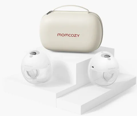 Two original Momcozy M5 wearable pumps beside their cream storage case.