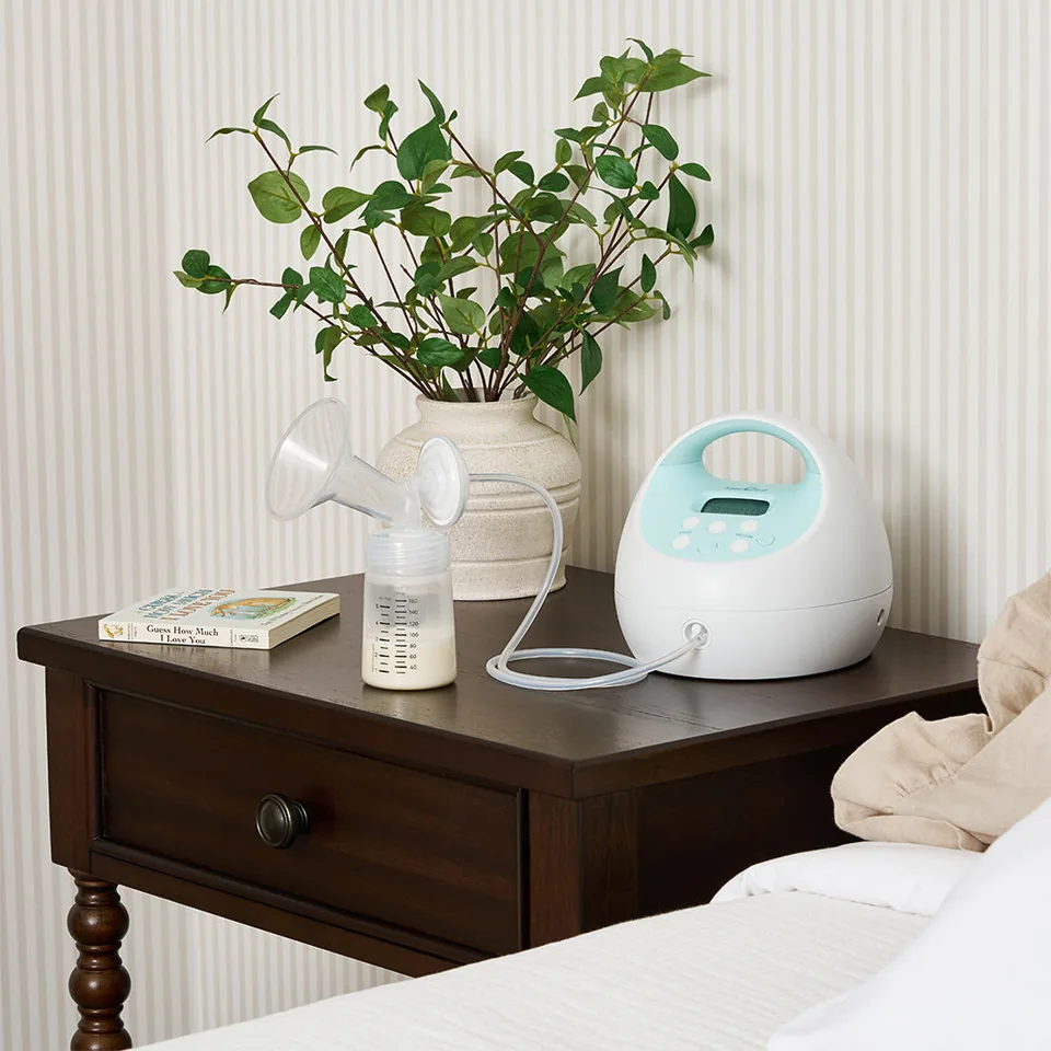 Spectra S1 Plus connected to a collection bottle on a bedside table.